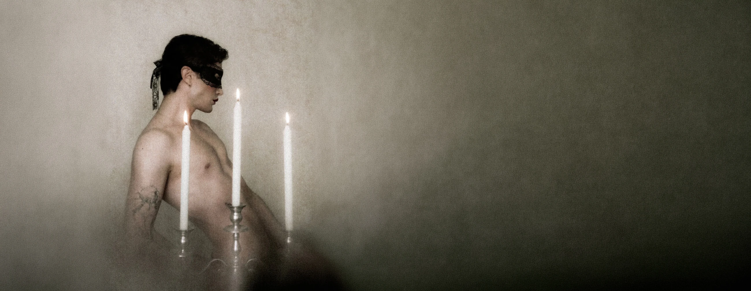 Masked figure with candles